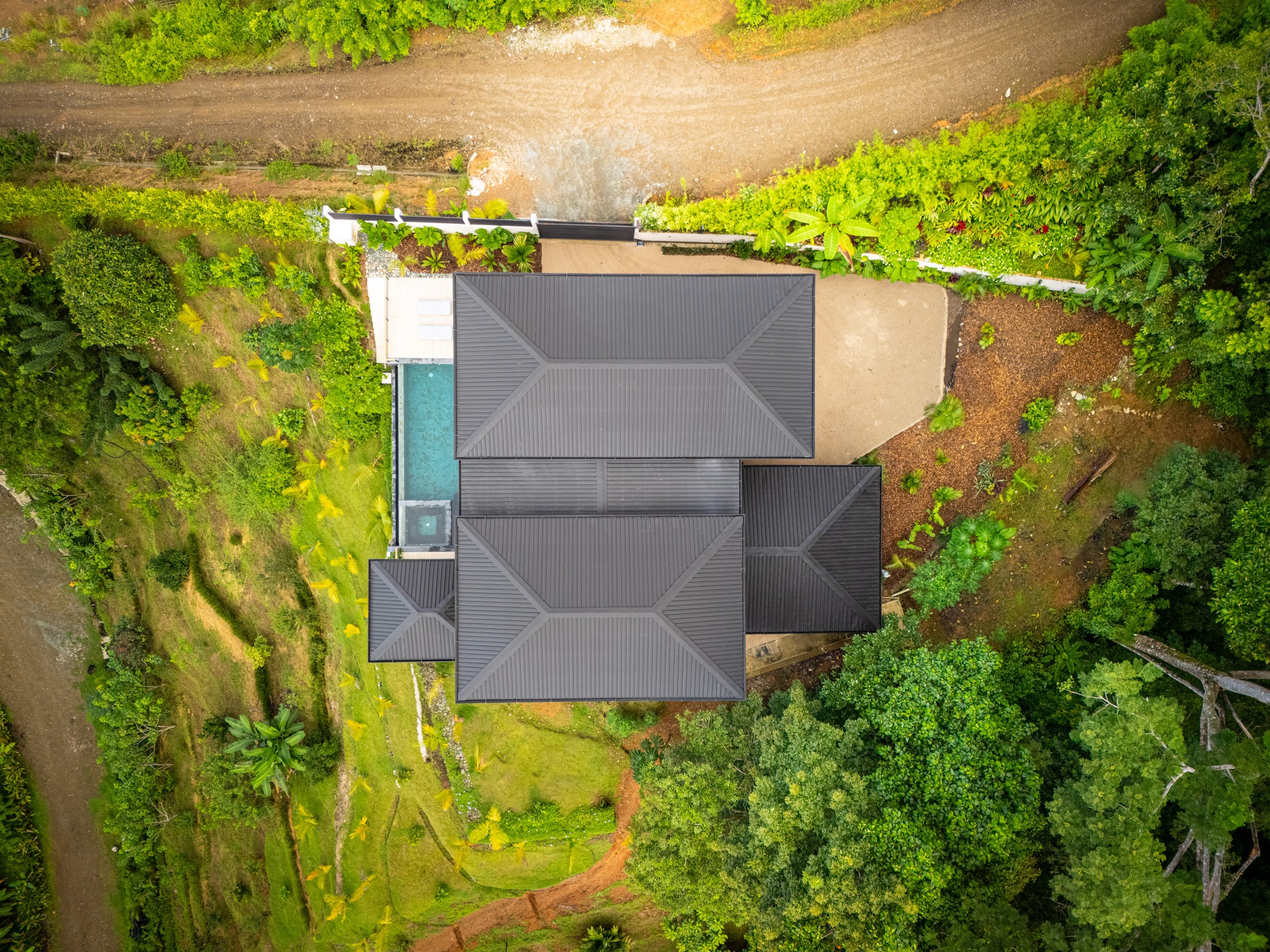 Bird's-eye view of Villa Del Cielo set in the jungle hillside of Farmstead Collection