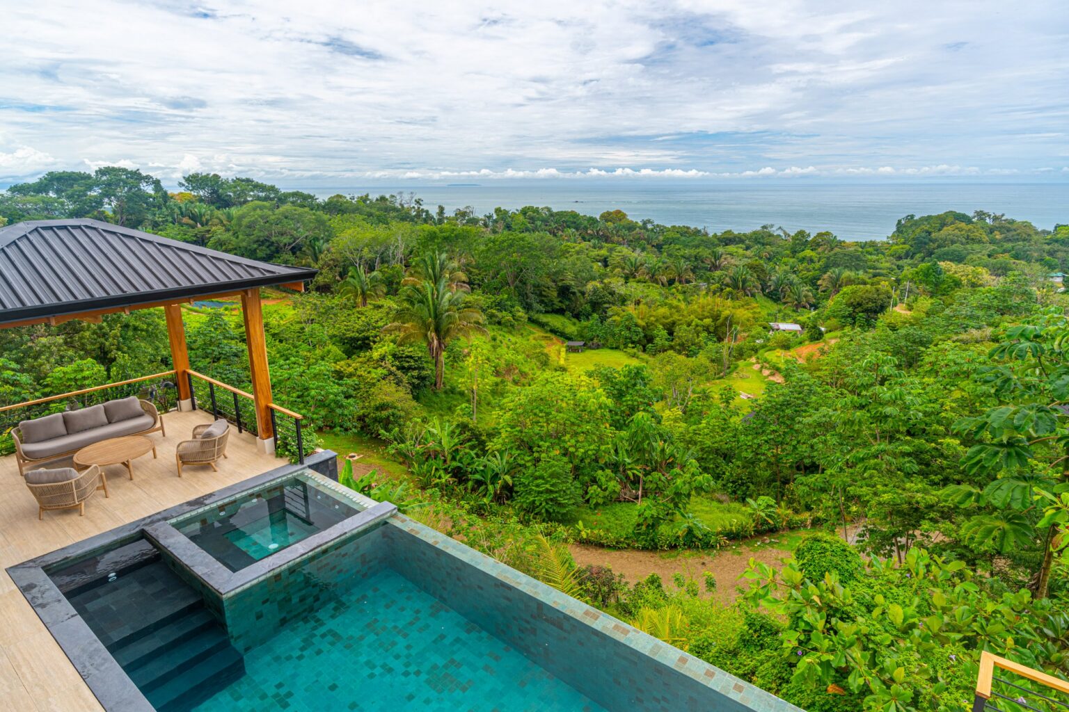 Villa Del Cielo infinity pool and terrace overlooking restored green hillside and the Pacific